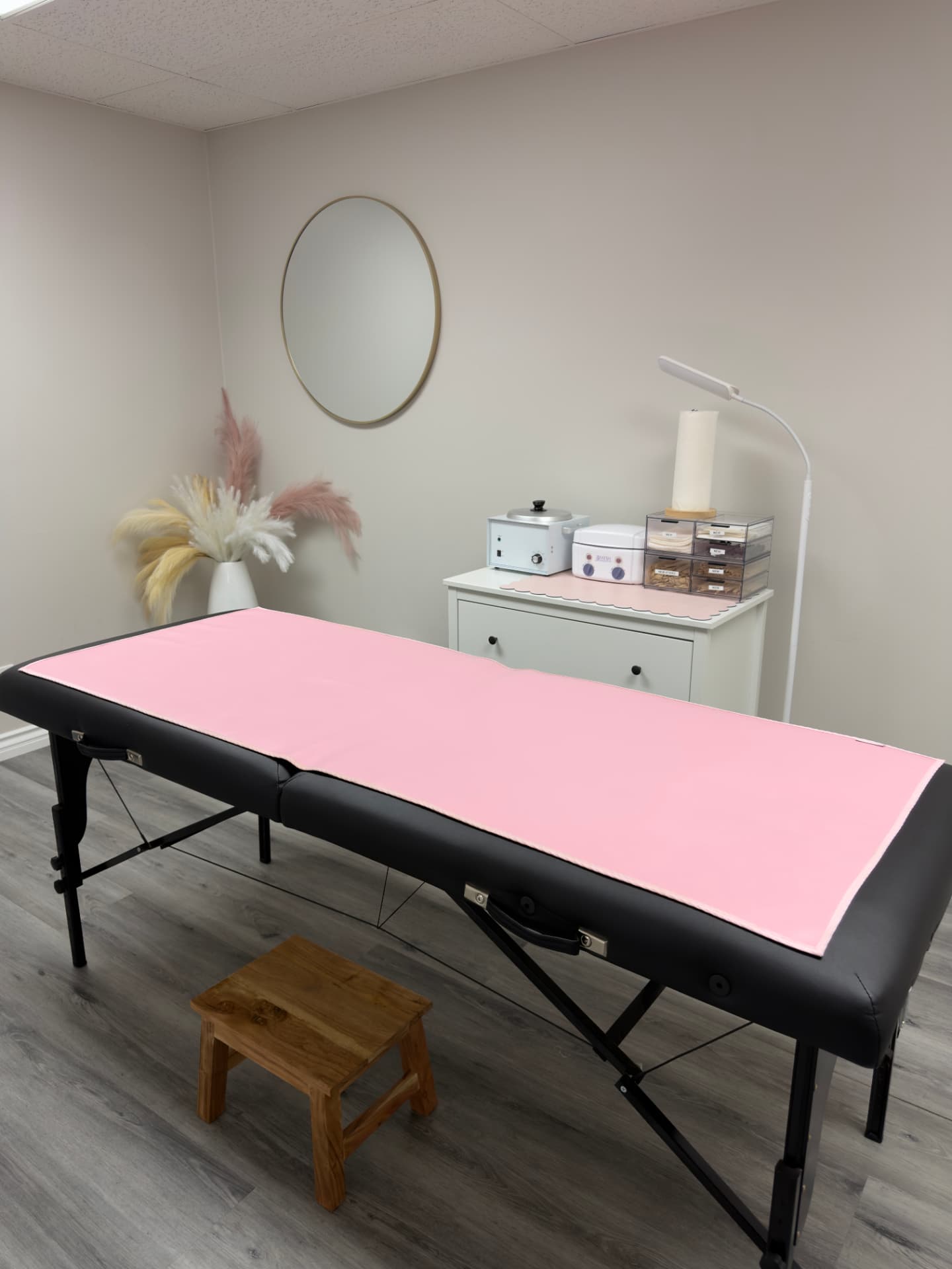 Private waxing room at Eres Beauty Studio in Santa Ana with a pink-draped treatment bed, wax warmers and soft neutral decor